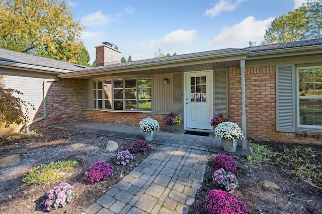 view of exterior entry with covered porch