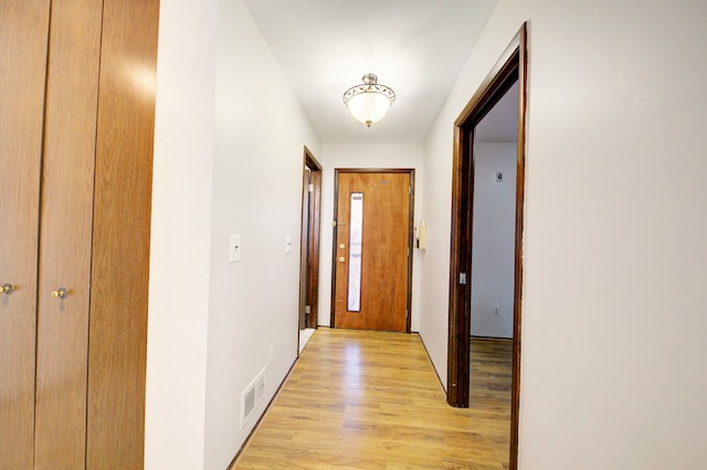 doorway to outside with visible vents and light wood-style floors