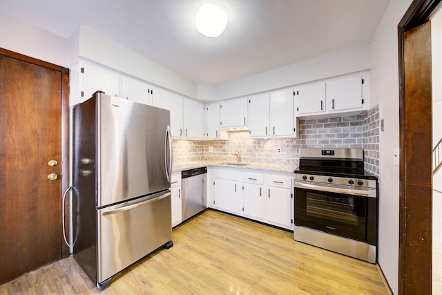 kitchen featuring white cabinetry, light wood-type flooring, sink, and appliances with stainless steel finishes