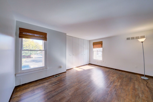 empty room with dark hardwood / wood-style floors