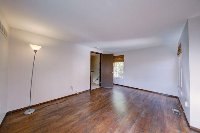 empty room with dark hardwood / wood-style floors