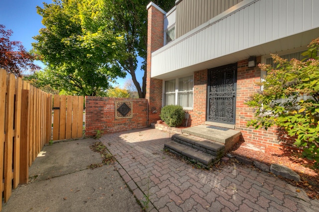 view of patio with a gate and fence