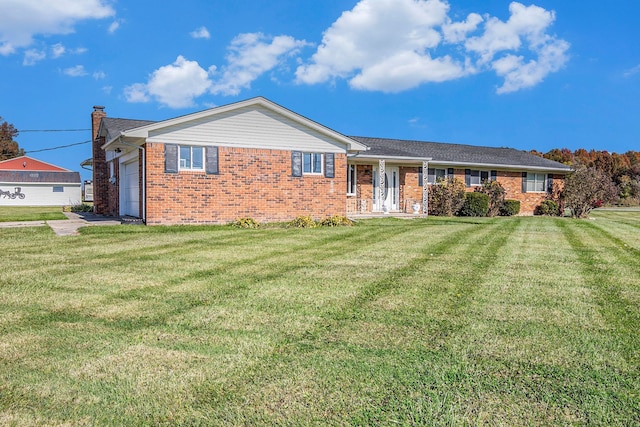 ranch-style house featuring a garage and a front lawn