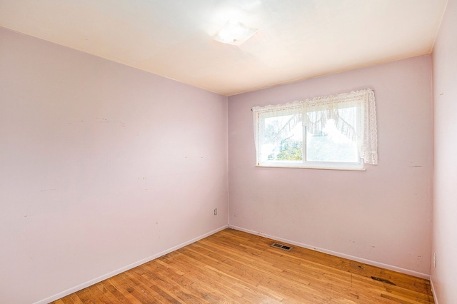 spare room with light wood-type flooring