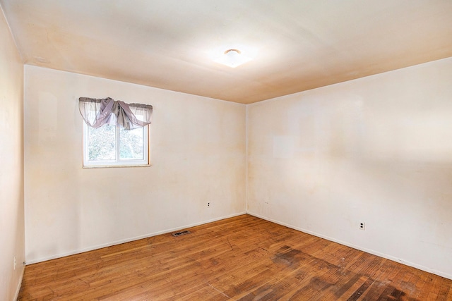 empty room featuring wood-type flooring