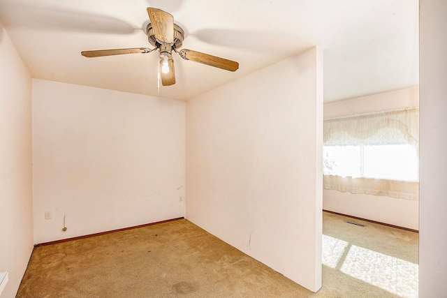 empty room featuring light carpet and ceiling fan