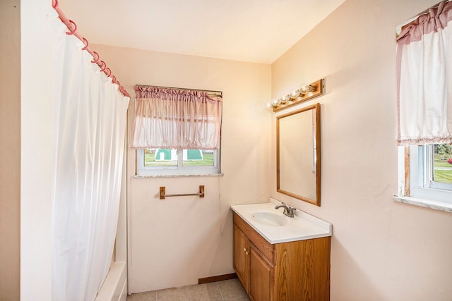 bathroom with tile patterned floors, shower / tub combo with curtain, and vanity