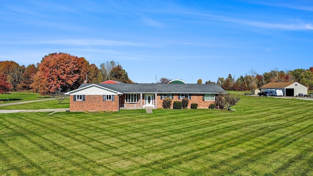 single story home with covered porch and a front yard