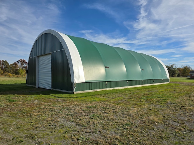 view of outdoor structure featuring a lawn