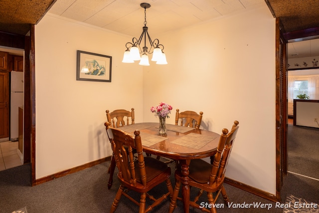 dining room featuring carpet flooring and a chandelier