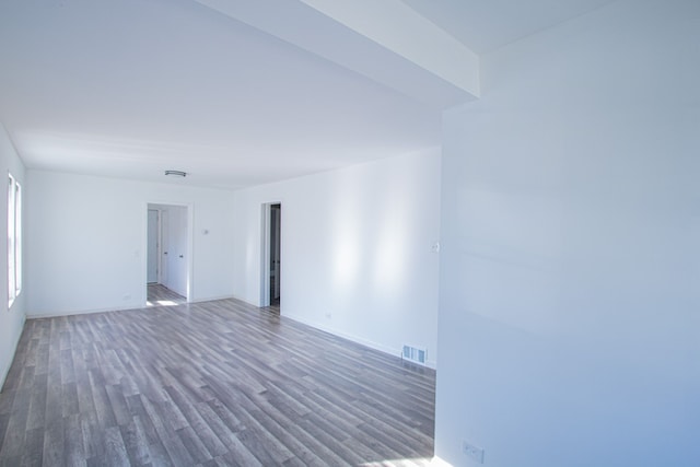 unfurnished room with dark hardwood / wood-style flooring