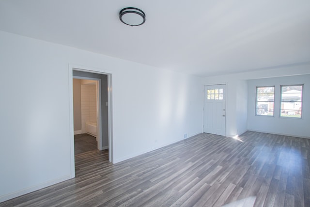 unfurnished living room with dark hardwood / wood-style floors