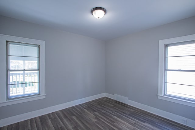 spare room featuring dark hardwood / wood-style floors