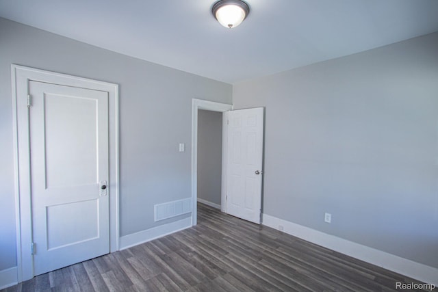 23930 Elmira St, Saint Clair Shores, MI 48082 - unfurnished bedroom with wood finished floors and baseboards