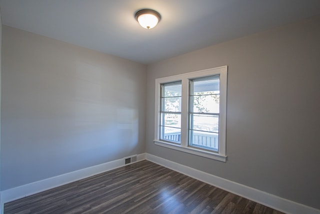 spare room featuring dark hardwood / wood-style flooring