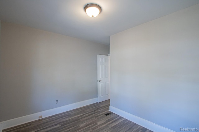23930 Elmira St, Saint Clair Shores, MI 48082 - unfurnished room featuring baseboards and dark wood-type flooring