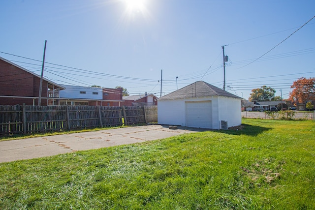 view of yard with a garage and an outbuilding