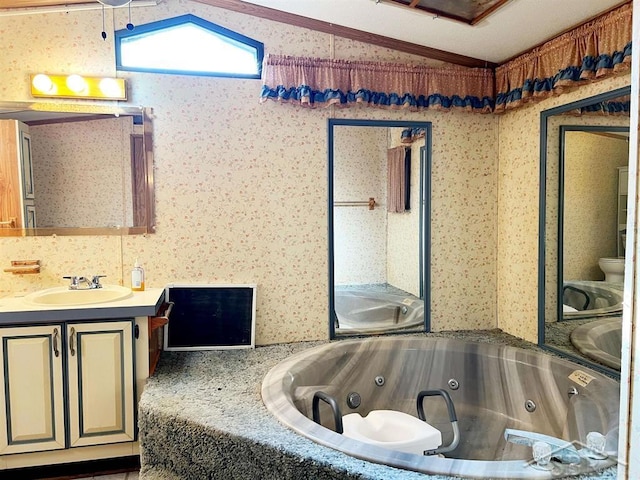 bathroom with crown molding, lofted ceiling, toilet, a bathtub, and vanity