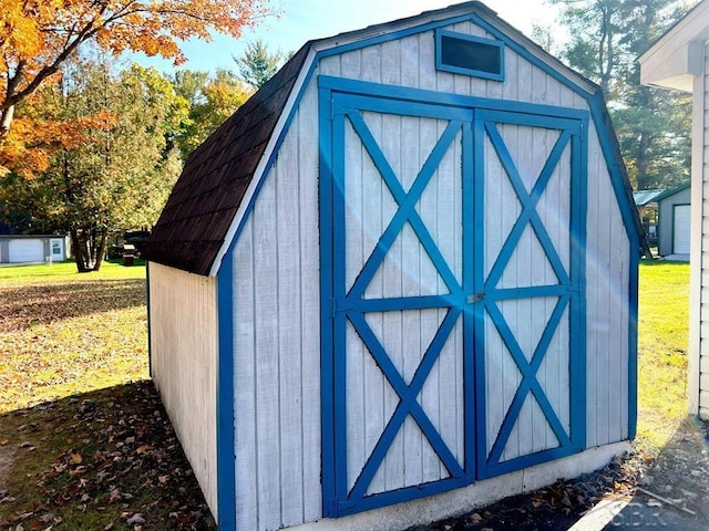 view of outdoor structure featuring a lawn