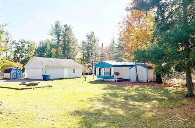 view of yard featuring a garage and a storage unit