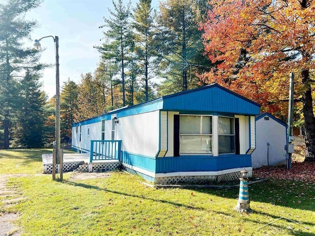 view of side of property with a lawn