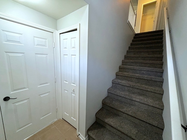 stairs featuring tile patterned floors