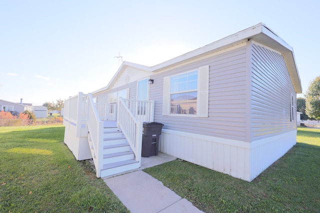 view of side of home with a lawn