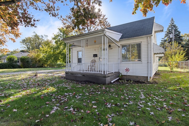 view of front of home with covered porch and a front yard