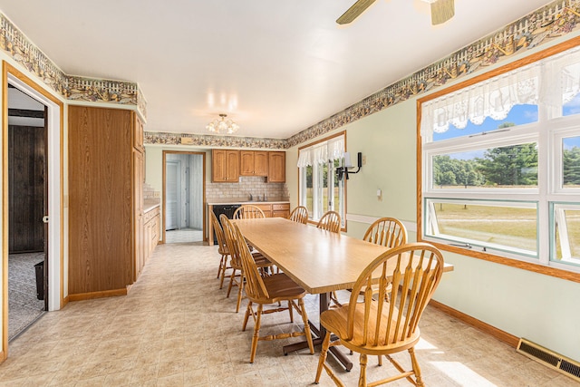 dining room featuring ceiling fan and sink