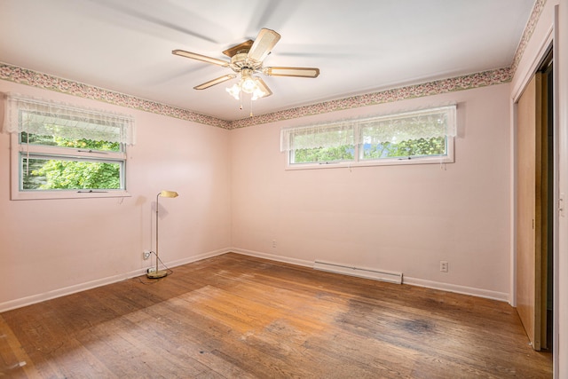 unfurnished room with hardwood / wood-style flooring, a baseboard radiator, and ceiling fan