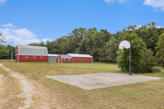 view of yard with basketball hoop