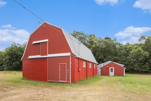 view of outbuilding with a yard