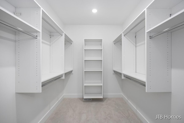 walk in closet with carpet