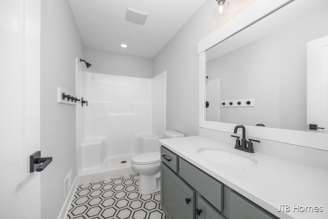 full bath with a shower, vanity, and toilet