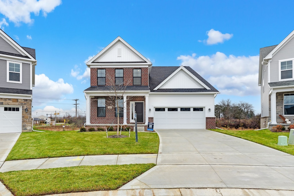 view of front of property with a garage and a front yard