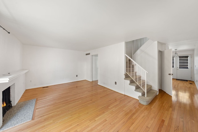 unfurnished living room featuring light wood-type flooring