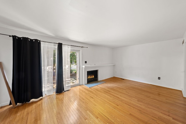 unfurnished living room featuring light hardwood / wood-style floors