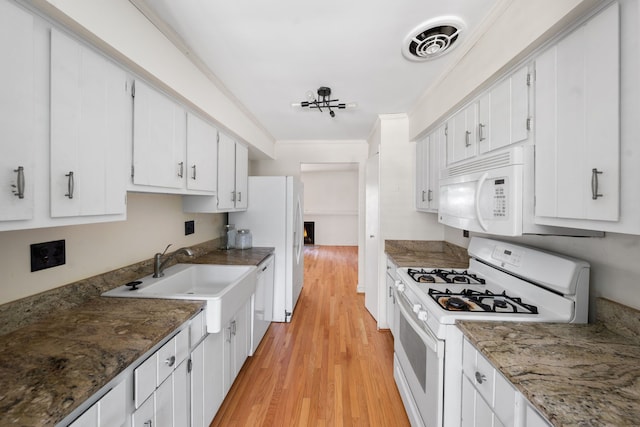 kitchen featuring white appliances, crown molding, sink, light hardwood / wood-style floors, and white cabinetry