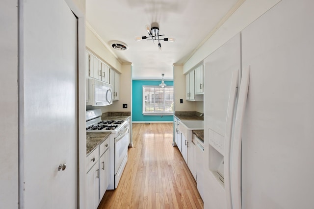 kitchen with hanging light fixtures, light wood-type flooring, white appliances, white cabinets, and ornamental molding