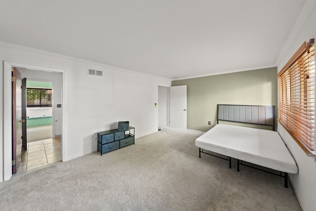 bedroom with crown molding and light colored carpet