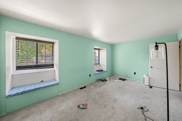 carpeted empty room with a healthy amount of sunlight