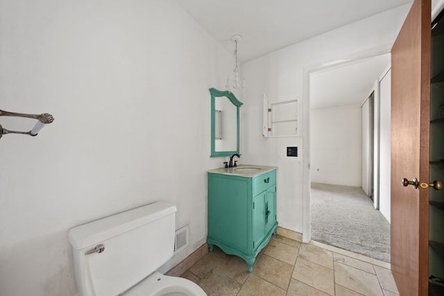 bathroom featuring vanity and toilet