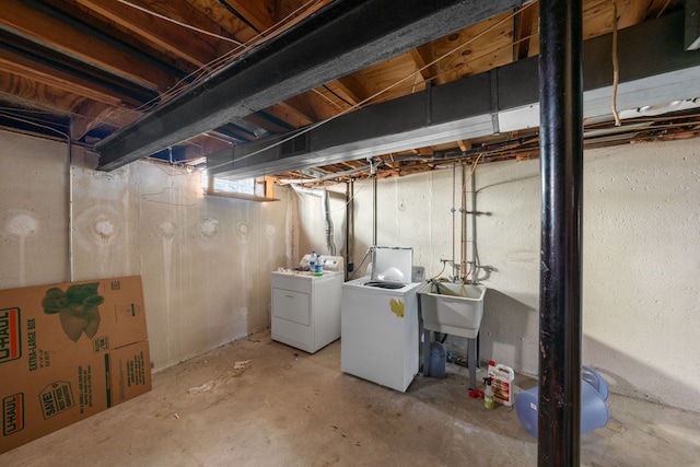 basement with separate washer and dryer and sink