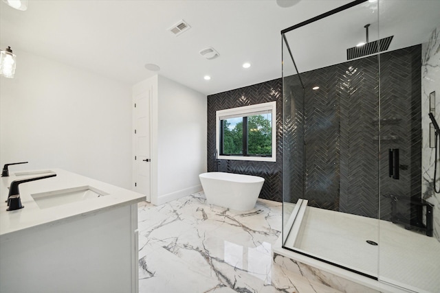 bathroom with vanity and shower with separate bathtub