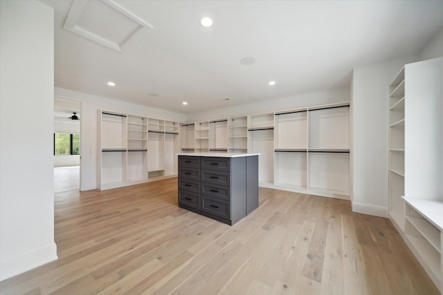 spacious closet featuring ceiling fan and light hardwood / wood-style floors