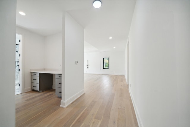 corridor with light hardwood / wood-style floors