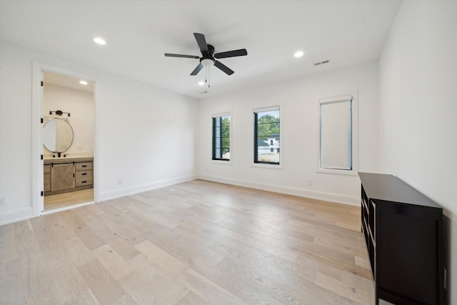 unfurnished living room featuring light wood-type flooring and ceiling fan