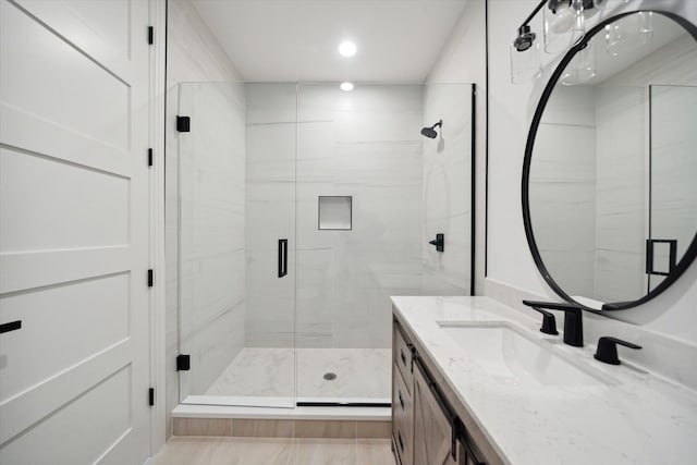 bathroom featuring vanity and an enclosed shower