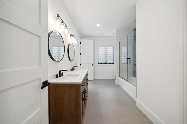 bathroom featuring vanity and combined bath / shower with glass door