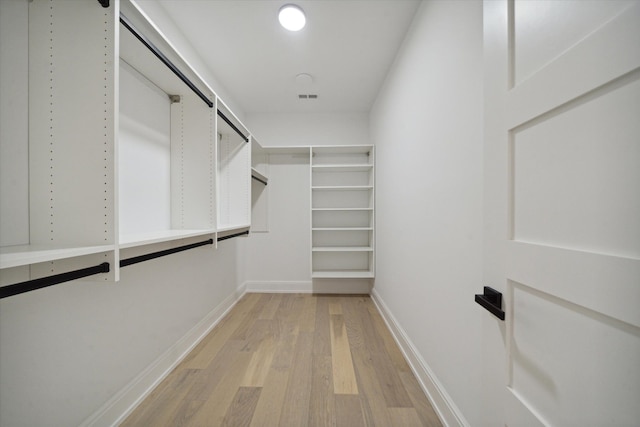 walk in closet with light wood-type flooring